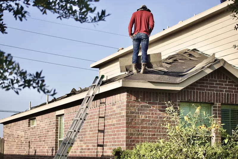 Professional roofer working on a residential roof in Brooklawn